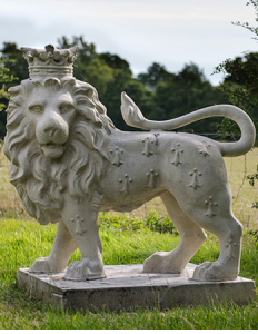 Lion statue for garden wearing crown hand made from cast stone in the UK
