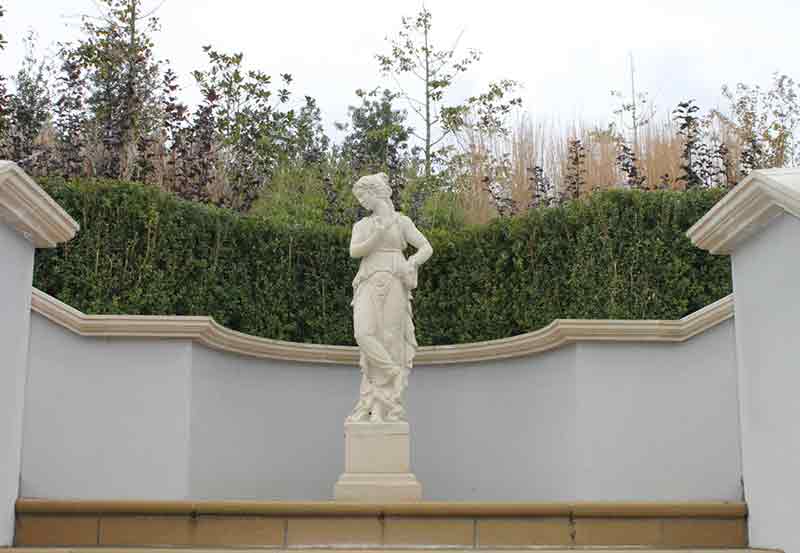 Concrete coping stone behind a beautiful cast stone statue