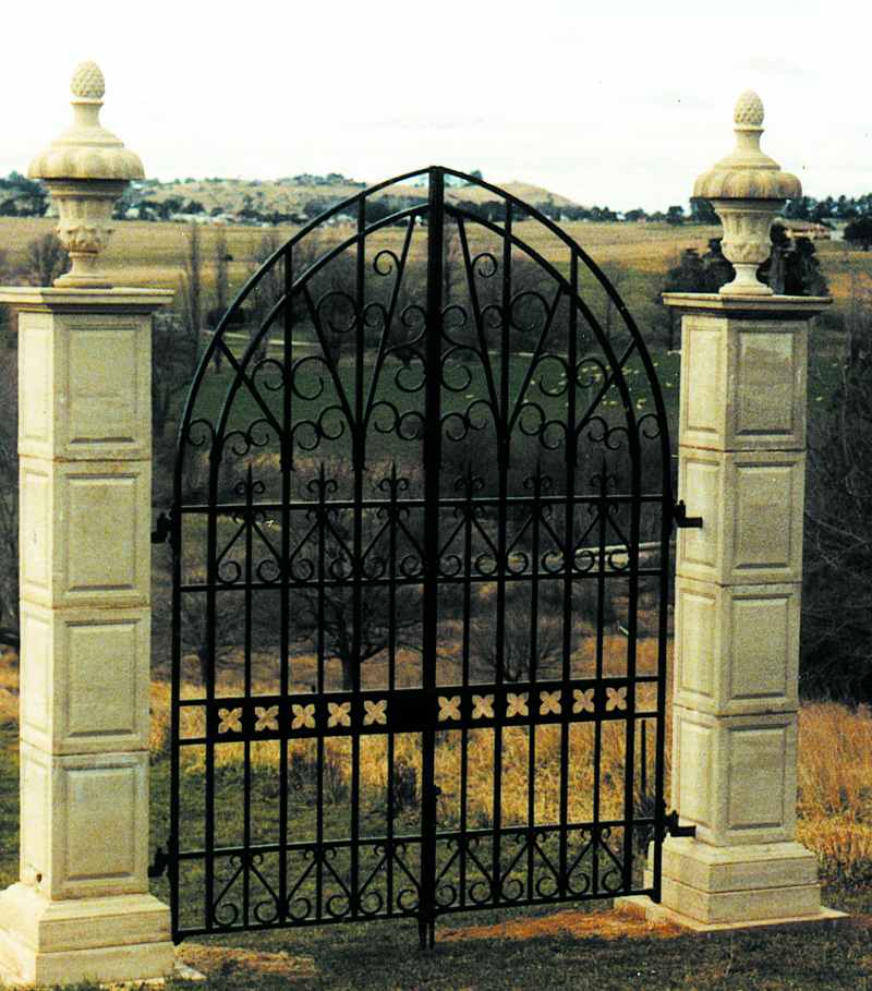 Traditionally styled gates that are now vintage as they have been in place for decades. Topped with classic finials for a rural setting.