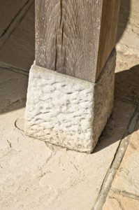 Close up of a Staddle stone on an oak post