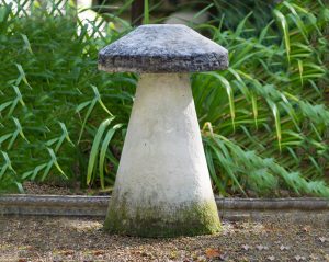 Close up of a mushroom stone or staddle stone in the Chilstone show garden, A traditional mushroom shaped Chilstone staddle stone.