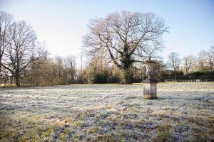 stone urn on a frosty morning in the english countryside