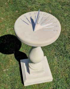 A Chilstone Coronation sundial with an engraved face place instead of a traditional brass sundial plate.