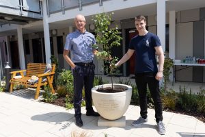 Chilstone General Manager Steve Clark with Antonio who gained work experience with Chilstone, standing by the engraved planter made by Chilstone for the opening of Ruben House for Charity Centrepoint. Photo by Rebekah Kennington
