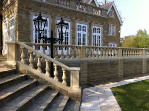 Chilstone raked balustrade along a garden steps leading from a patio.