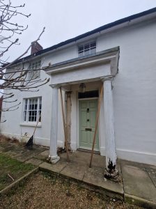 Wooden portico with rotten columns.