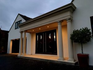 The large bespoke Chilstone portico unifies the two main gables of the house. Rendered and painted in white, the colour scheme brings the building together in a chic, contemporary finish.