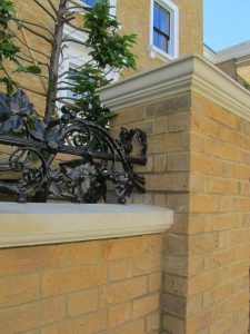 A low garden wall topped with smart Chilstone coping stones to restore the Victorian details and protect brickwork. 