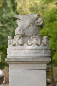 A bespoke cast stone finial made by Chilstone, depicting a bull's head inside an ornate crown.
