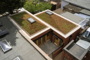 A modern home design with a living roof finished with Chilstone's handmade coping stones.